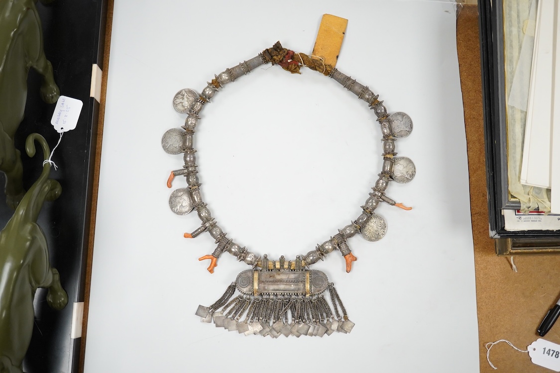 A Bedouin white metal and coral mounted necklace, from Oman, 58cm long